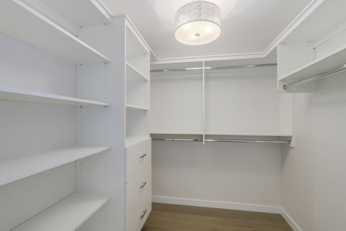 A walk-in closet with organizers